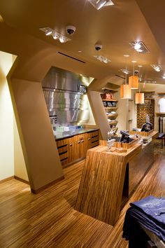 a room filled with lots of counter top space and wooden flooring next to a kitchen