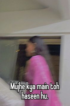 a blurry image of a woman in pink walking past a computer screen with the words mujhe ky main toh haseen hu