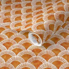 an orange and white wallpaper with fan design on it's surface, showing the pattern