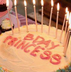 a birthday cake with lit candles on it