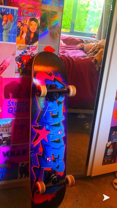 a skateboard is standing upright in front of a wall full of pictures and posters