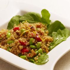 a white bowl filled with vegetables and grains