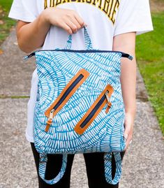 a person holding a blue and white bag