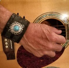 My cuff collection are designed to inspire the Rock Star in us all. In addition to having a personality of their own I have offered them with many unique conchos that will allow you to express your individual personality. If this cuff doesn't speak to you then please go to my page and look at the other cuffs I offer. If nothing on my page is calling your name then contact me as I would love to make you something custom. The cuffs are made with the finest full grain vegetable tanned leather and a Concho Jewelry, Turquoise Dog Collar, Johnny Depp Style, Leather Wrist Cuff, Matching Keychains, Real Turquoise, Turquoise Leather, Leather Bracelets, Bracelet Black