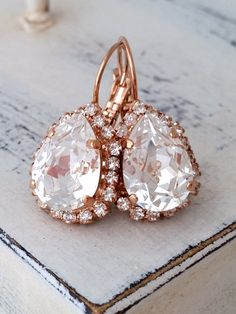 "White clear crystal teardrop earrings, Drop earrings, Bridal earrings, Bridesmaid gift, Dangle earrings Gold or silver earring, Drop or stud Elegant and refined. These earrings are so sparkly. They would be great as bridal earrings or for any other day. Perfect gift for bridesmaids or other occasions. They are made of rose gold plated brass and Swarovski crystals, all set in prong setting. Made with CRYSTALLIZED™ - Swarovski Elements Each teardrop is approx. 19 x 15 mm Total earring's length is Rose Gold Drop Bridal Earrings For Anniversary, Rose Gold Drop Bridal Earrings, White Pear-shaped Crystal Earrings Gift, Rose Gold Dangle Earrings With Prong Setting, Rose Gold Crystal Dangle Earrings, Sparkling Rose Gold Drop Earrings, Rose Gold Pear-shaped Earrings For Anniversary, Sparkling Rose Gold Crystal Earrings, Rose Gold Teardrop Pendant Earrings For Gift