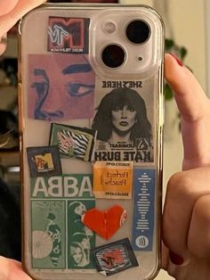 someone holding up a cell phone case with stickers all over it and an image of a woman's face