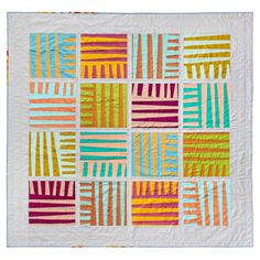 a multicolored patchwork quilt on a white background with blue and yellow stripes