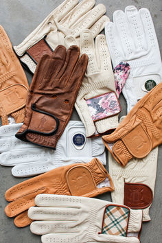 many pairs of gloves are laid out on the ground together, including one for men and one for women