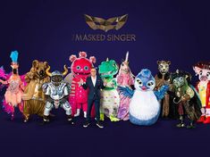 a group of people dressed in animal costumes standing next to each other on a purple background