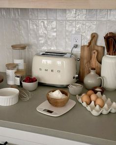 the kitchen counter is cluttered with food and utensils, including an electric toaster