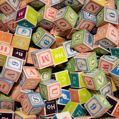 many different colored blocks with numbers and symbols on them, all stacked up in the shape of cubes