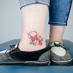 a woman's foot with a small tattoo on the side of her leg,