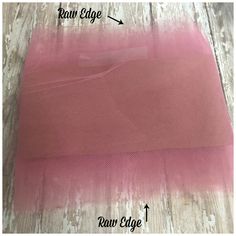 a piece of pink fabric on top of a wooden floor with the words raw edge