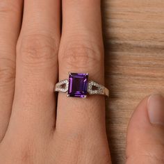 It is a natural amethyst ring. The main stone is 7 mm* 9 mm emerald cut.weight about 2.21 carats. The basic metal is sterling silver and plated with rhodium. To change the metal to a solid gold (white/rose) or platinum is also available, please ask for a quotation if you want. You can also go to my shop Home for more elegant rings: https://www.etsy.com/shop/godjewelry?ref=hdr_shop_menu Amethyst is February birthstone More amethyst rings: https://www.etsy.com/shop/godjewelry?ref=seller-platform-m Elegant Emerald Cut Amethyst Promise Ring, Elegant Emerald Cut Amethyst Ring, Emerald Cut Amethyst Ring In White Gold, Elegant Emerald-cut Amethyst Birthstone Ring, Elegant Emerald Cut Amethyst Birthstone Ring, Elegant Amethyst Ring With Rectangular Stone For Anniversary, Elegant Rectangular Amethyst Ring For Anniversary, Purple Emerald-cut Birthstone Ring For Anniversary, Elegant Solitaire Amethyst Ring With Emerald Cut