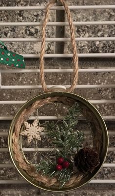 an ornament hanging from a rope with snowflakes and pine cones on it