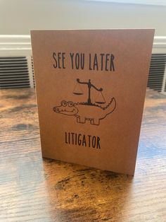 a card that says see you later alligator on the front, and an image of a scale