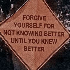 a sign that is on the side of a tree saying, forgve yourself for not known better until you knew better