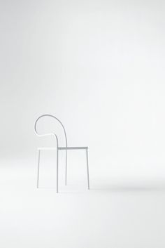 a white chair sitting on top of a white floor