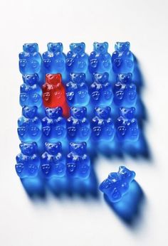 there are many blue legos arranged in the shape of a bear and one is red