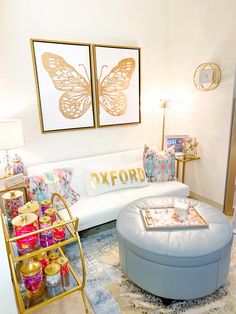 a living room filled with lots of furniture and paintings on the wall above it's coffee table