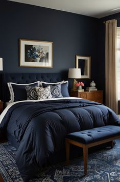 a bed with blue comforter and pillows in a bedroom