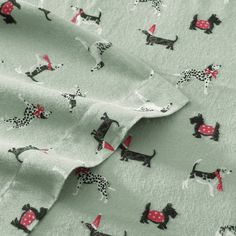 the fabric has dogs and polka dots on it