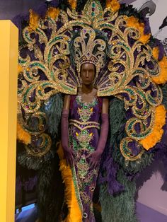 a woman in a purple and gold costume