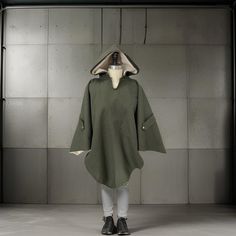 Embrace the chilly seasons in style with our Olive Green Hooded Poncho. Crafted with a rich, textured fabric, this oversized poncho is a must-have for anyone looking to add a touch of elegance and comfort to their wardrobe. The roomy poncho offers both warmth and ease of movement, making it an ideal choice for layering over any outfit. Whether you're out for a casual walk or enjoying an evening out, our unisex cape is versatile enough to complement any look. With its cozy hood, this poncho is not just a fashion statement but also a practical piece for staying snug against the cold breeze. Available exclusively on Etsy - your go-to destination for unique, handcrafted, and stylish autumn and winter clothing. One Size Cotton Winter Outerwear, Oversized Winter Poncho For Cold Weather, Oversized Winter Poncho, One Size Winter Outerwear For Outdoor, One Size Green Outerwear For Winter, Green One Size Winter Outerwear, Wool Poncho With Long Sleeves For Winter, One Size Green Winter Outerwear, Oversized Green Cape For Fall