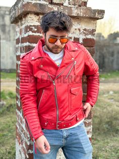 "Red Leather Biker Jacket Exterior: 1- Color: Red 2- 100% Real Leather 3- (3) Exterior Pockets. Button Wrist Cuffs. 4- Leather Thickness: 0.8-0.9mm Interior: 1- Lining: Premium Silk 2 Brand High Quality Woven Labels Designed in United State / Handmade by our team of artisans The Model is 5'10\"ft tall, weighs 175lbs and wears size US/M Note: We also do custom projects, For customization please provide the following measurements Chest: Shoulder to Shoulder: Shoulder to Sleeves: Length(neck to des Red Leather Biker Jacket For Streetwear, Red Fitted Biker Leather Jacket, Vintage Red Leather Biker Jacket, Red Moto Leather Jacket For Motorcycling, Red Winter Biker Jacket, Red Leather Biker Outerwear, Red Leather Outerwear For Biker Events, Red Leather Motorcycling Jacket, Red Fitted Biker Jacket For Motorcycling