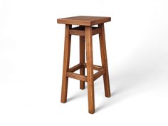 a wooden stool on a white background with no one around it or the seat up