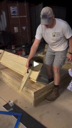 a man is working on some wooden furniture