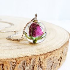 This tiny rose necklace is made from a real rose picked up from my garden: A rosebud necklace as the perfect unique gift for her. My real rose necklace is part of my pink rose jewelry collection. You will feel truly unique wearing this flower resin necklace! This tiny rose necklace comes with a hypoallergenic stainless steel chain; the resin provides a perfect crystalline shine which makes this real rose necklace sparkle under the sunlight. A real flower necklace is always the most romantic gift Delicate Rose Necklaces For Gifts, Rose Colored Round Pendant Jewelry For Gift, Rose Design Round Pendant Necklace As Gift, Rose Colored Jewelry With Round Rose Design Pendant, Delicate Rose Necklace For Gift, Dainty Rose Necklace As Gift, Rose Color Jewelry With Round Rose Design Pendant, Rose Flower Necklace For Gift, Rose Flower Necklace As Gift