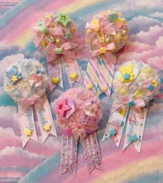 there are many different hair clips on the table with clouds and rainbows in the background