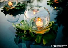 there are candles in the glass bowl on the table