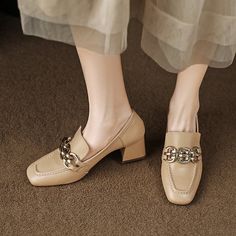 Looking for a unique and stylish way to add a little extra height to your look? Check out our amazing selection of loafer heels! These amazing shoes feature a square toe and a nude finish. with a gold chain detail that adds a touch of luxury. Whether you're dressing up for a special occasion or just want to add a little extra glamour to your everyday look. these shoes are sure to make you stand out from the crowd. Upper: Sheepskin Lining: Microfiber Outsole: TPR Toe: Square Toe Closure: Slip on Chic Formal Heels With Gold Chain, Elegant Formal Heels With Gold Chain, Trendy Beige Formal Loafers, Elegant Beige Square Toe Loafers, Formal Heels With Chain Strap And Square Toe, Trendy Formal Heels With Chain Detail, Gold Square Toe Heels For Office, Beige Square Toe Loafers For Formal Occasions, Chic Gold Loafers For Work