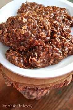 two cookies are stacked on top of each other in a white bowl with chocolate chips