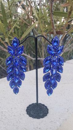 "Blue rhinestone dangle earrings These fun and stylish rhinestone long earrings with blue crystals are a great statement piece! Pageant, prom, or bridal! Size of earrings: 1\" Wide and 3.25\"Long. Color: Royal Blue with silver base metal color more colors available! just check our listings or message us! looking for a matching bracelet? check out bracelet listings! https://www.etsy.com/listing/594523565/blue-rhinestone-bracelet-royal-blue?ref=shop_home_active_1 https://www.etsy.com/listing/55855 Blue Prom Earrings, Drag Jewelry, Earrings For Saree, Royal Blue Earrings, Dressy Earrings, Pageant Earrings, Fun Ornaments, Prom Earrings, Orange Earrings