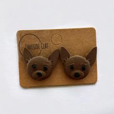 two small brown dogs with big ears are on a card