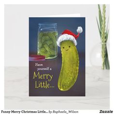 a christmas card with a pickle in a santa hat next to a jar of pickles