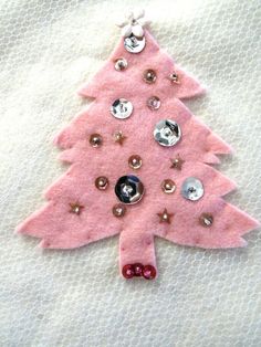 a pink felt christmas tree ornament with buttons