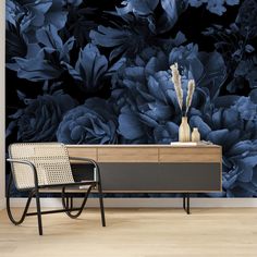 a black and blue floral wallpaper mural in a living room with a modern chair