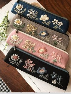 four different colored flowers on black and white headbands