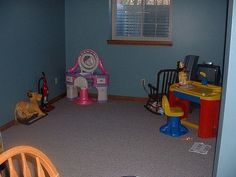 a child's playroom with toys and other items in the room on the floor