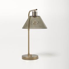 a lamp that is on top of a white surface with a light bulb in the middle