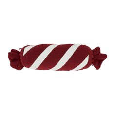 a red and white striped pillow with tassels on the ends, sitting in front of a white background