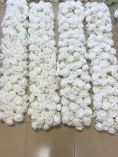 three rows of white roses laid out on the floor