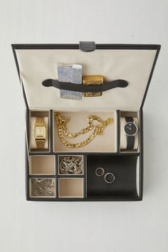 Add a luxe finish to your getting-ready space with this jewelry storage box from Mele and Co Crafted from vegan leather with sand suede lining, this storage box features seven compartments in a variety of sizes to hold all of your essentials. Complete with two padded watch cushions and a coin slide. Finished with a slim storage strap under the lid to hold your cash, lighters and more. Features Luxe vegan leather watch box from Mele and Co Lined with sand suede 4 Small compartments 2 Watch compar Classic Rectangular Watch Storage Accessories, Timeless Rectangular Watch Case, Elegant Portable Rectangular Jewelry Storage Case, Leather Watch Box, Watch Storage Box, Watch Storage, Luxury Jewelry Storage Box, Rectangular, Watch Box, Storage Box