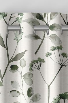 a close up of a curtain with green leaves on it and watercolor style paint