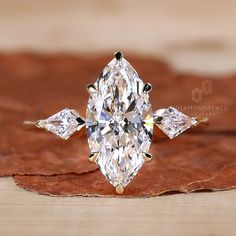 a fancy ring with three pear shaped diamonds