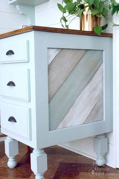 a white cabinet with drawers and plants on top